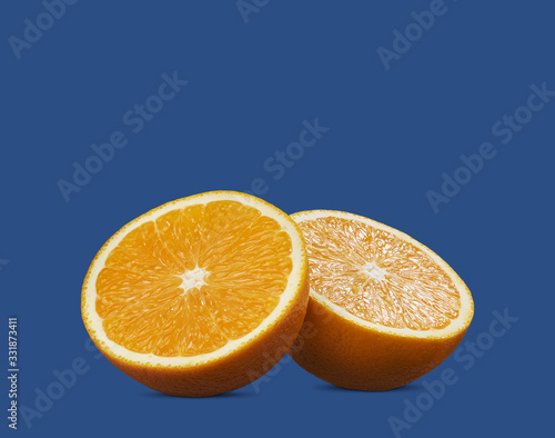 half of orange fruit on blue background