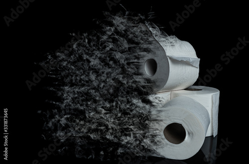 roll of toilet paper disappearing on black background