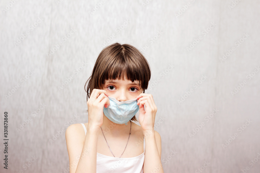 Girl with a medical mask on her face.