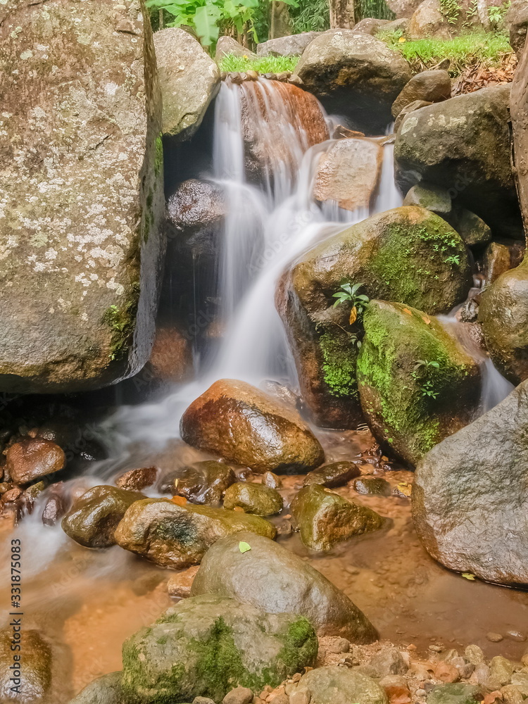 view of silky stream water flowing on arch rocks background, Pong Phra Bat Waterfall, Chiang Rai, northern of Thailand. view of silky stream water flowing on arch rocks background, Pong Phra Bat Waterfall, Chiang Rai, northern of Thailand.