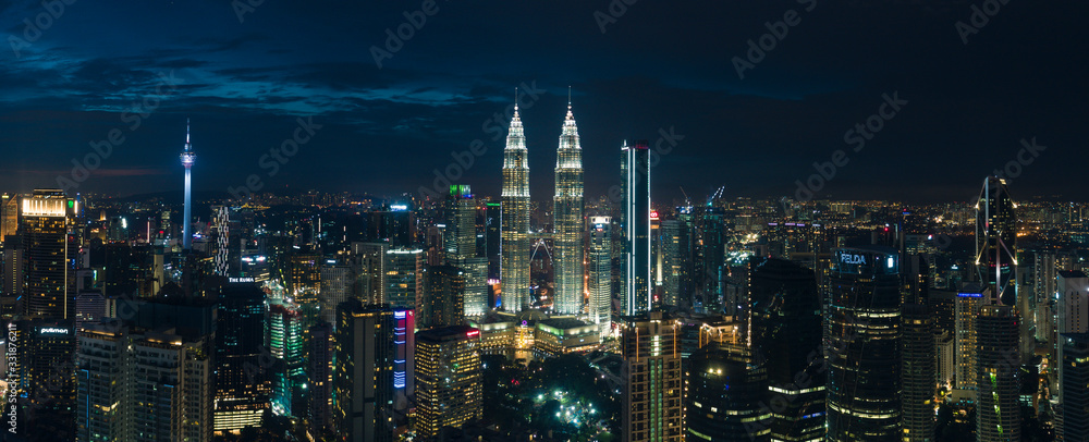 Aerial night view by drone of buildings and landmarks centre Kuala Lumpur city.