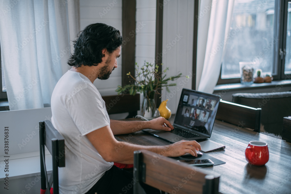 Workplace at home. A man works at a laptop at home