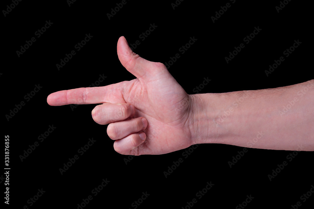 Hand of caucasian man shows the finger gun sigh on isolated black background Hand of caucasian man shows the finger gun sigh on isolated black background