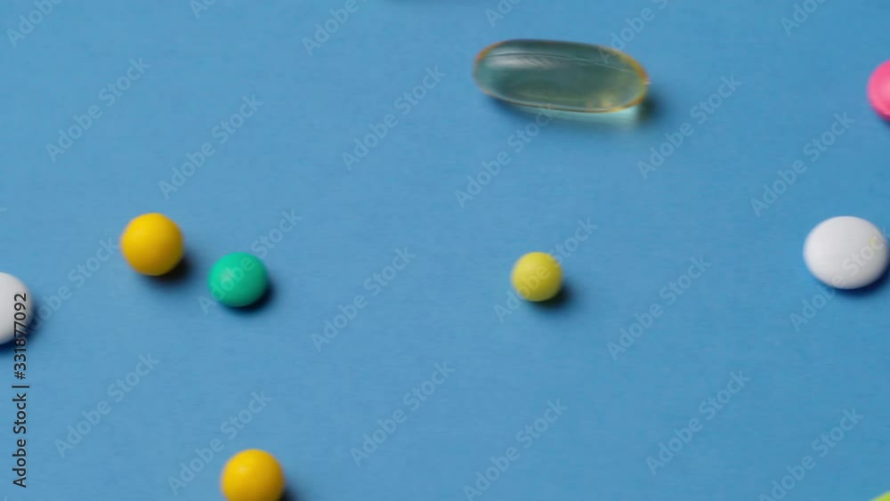 Background of pills, tablets, vitamins, drugs, omega 3 fish oil, gel capsules, medicament and food supplement for health care on blue Background of pills, tablets, vitamins, drugs, omega 3 fish oil, gel capsules, medicament and food supplement for health care on blue