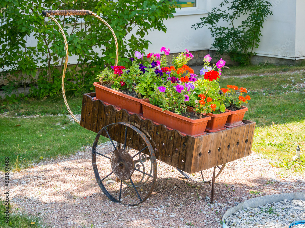 Flowerbed stylized as an old hand cart