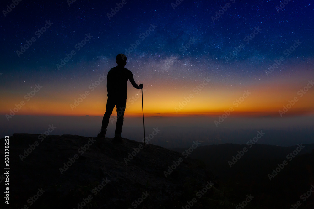 Fototapeta premium Landscape with Milky Way. Night sky with stars and silhouette of a standing happy man on the mountain,Outer Space, Star - Space, Milky Way, Night, Mountain Climbing