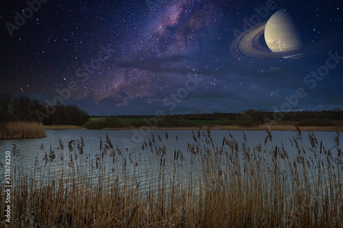 above lake is the clear starry sky with the Milky Way and Saturn