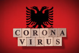 Flag of Albania with wooden cubes spelling coronavirus on it. 2019 - 2020 Novel Coronavirus (2019-nCoV) concept, for an outbreak occurs in Albania.