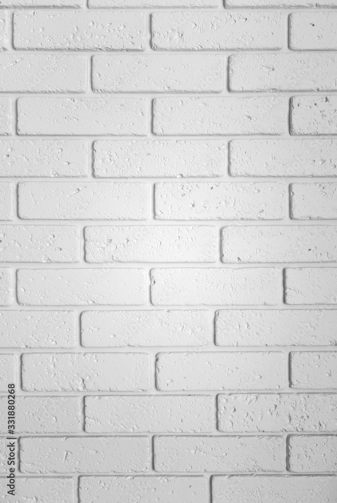 Fototapeta premium Brick wall texture, close up. Vertical white textured wallpaper