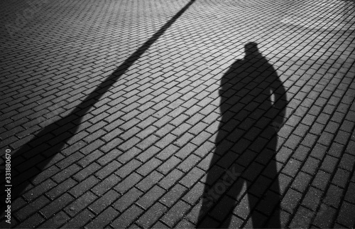 Man silhouette on street pavement background