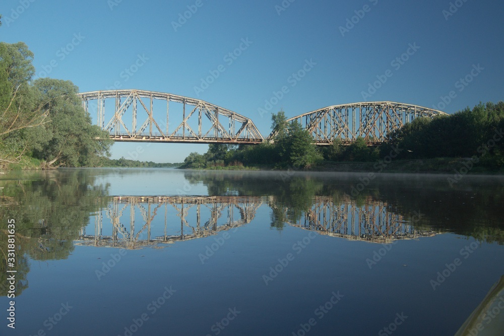 Railway bridge over the river. Bug valley. View of the metal structure of the river.