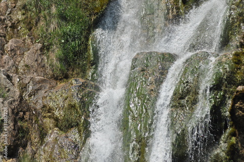 High waterfall  the water flowing from the rocks into the lake. National Park Plitvice Lakes. Tourism in Croatia.