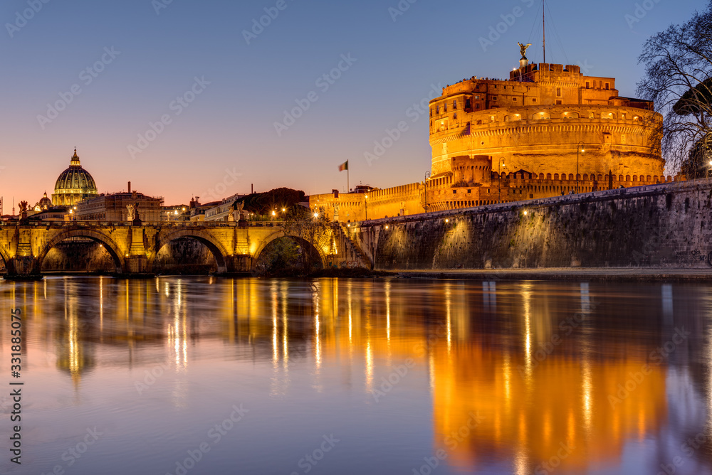 The Castel Sant Angelo and the St. Peter's Basilica in Rome at dusk