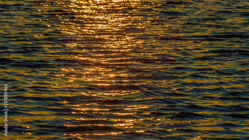 River at sunset, reflection of sunlight on the surface of the river water_