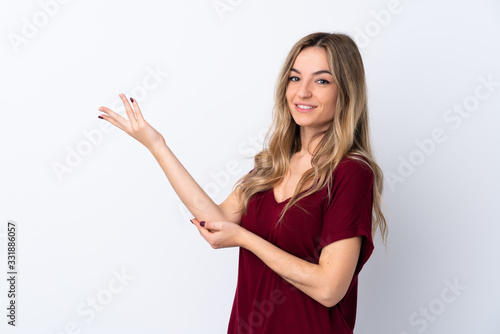 Wallpaper Mural Young woman over isolated white background extending hands to the side for inviting to come Torontodigital.ca