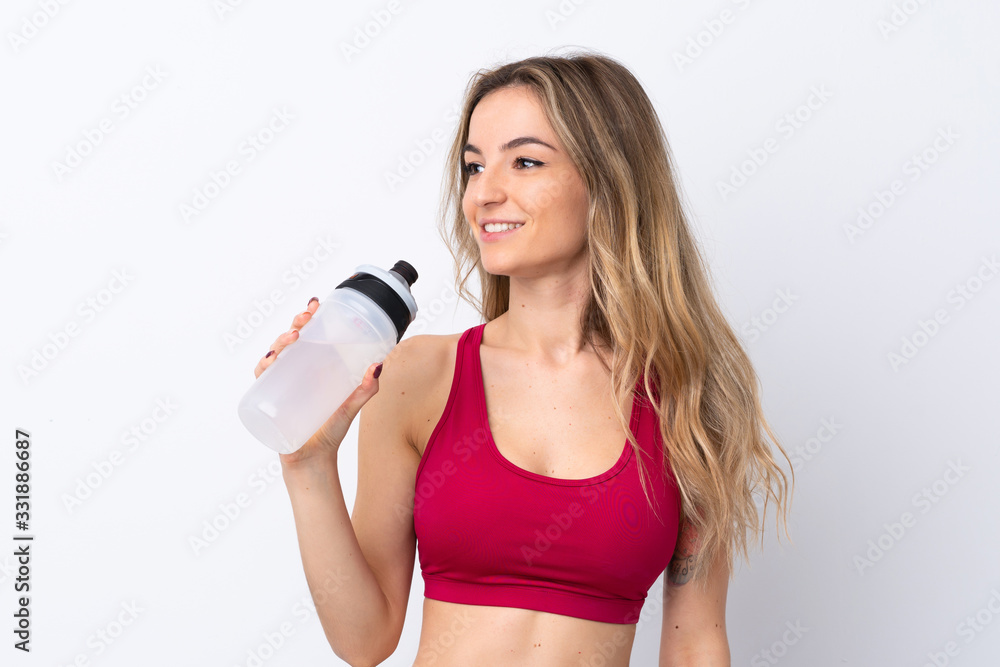 Young sport woman over isolated white background with sports water bottle Young sport woman over isolated white background with sports water bottle