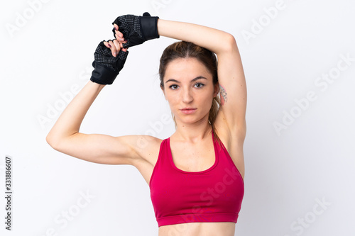 Young sport woman over isolated white background stretching