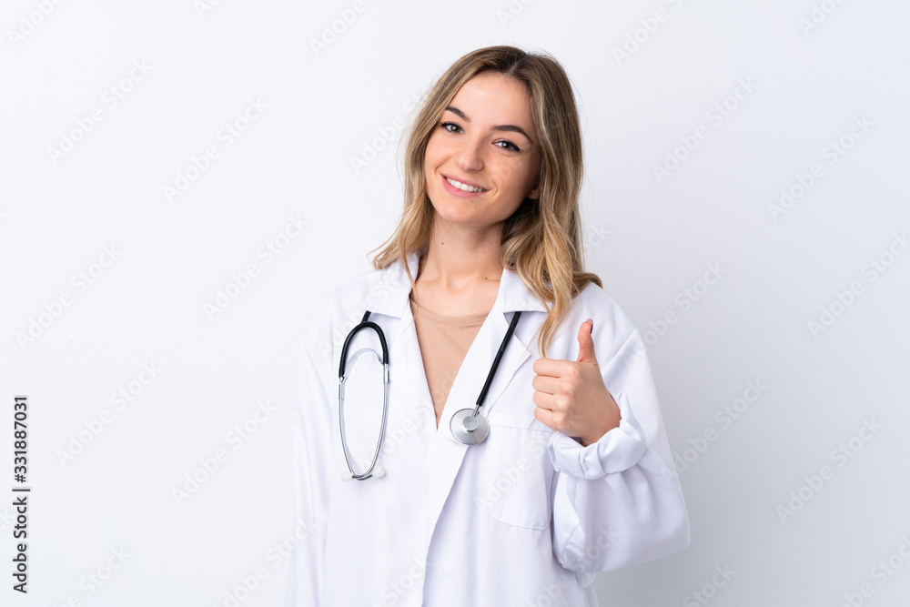 Young woman over isolated white background wearing a doctor gown and with thumb up