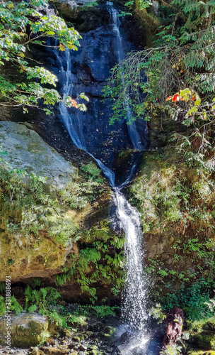 Flowing Steep Creek Falls in the mountains of Skamania County thru the boulders and vegetation in Washington State photo