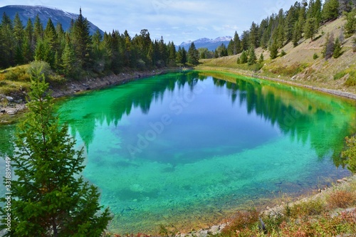 Beautiful blue lake high in the mountains surrounded by forest. Valley of Five Lakes, Jasper, Rocky Mountains, Canada.