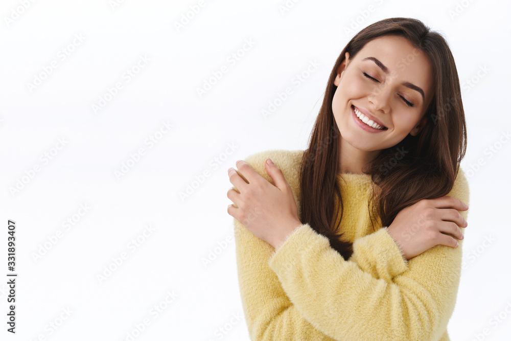 Tenderness, beauty and women concept. Romantic passionate young beautiful woman embracing own body in warm hug, feel cozy and happy, close eyes tilt head and dreaming, white background Tenderness, beauty and women concept. Romantic passionate young beautiful woman embracing own body in warm hug, feel cozy and happy, close eyes tilt head and dreaming, white background