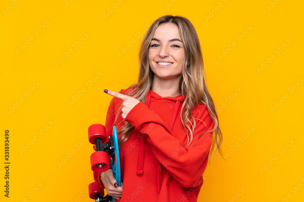 Young woman over isolated yellow background with a skate and pointing to the side Young woman over isolated yellow background with a skate and pointing to the side