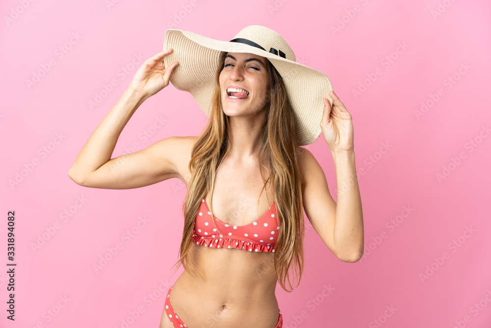 Young blonde woman over isolated pink background happy in swimsuit in summer holidays Young blonde woman over isolated pink background happy in swimsuit in summer holidays