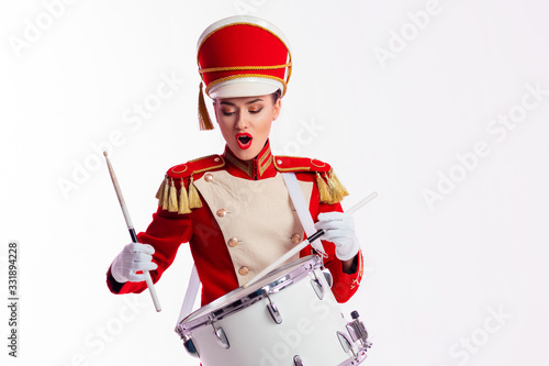 drummer in a red uniform drums on a drum, show program