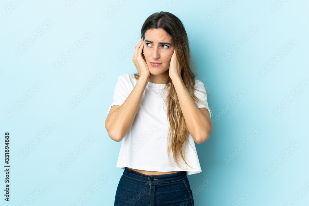 Young caucasian woman over isolated background frustrated and covering ears Young caucasian woman over isolated background frustrated and covering ears