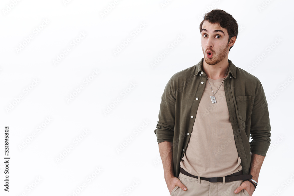 Portrait of surprised and excited young man say wow and stare impressed camera, feel astonished listening shocking big news, react amazed and speechless, white background Portrait of surprised and excited young man say wow and stare impressed camera, feel astonished listening shocking big news, react amazed and speechless, white background
