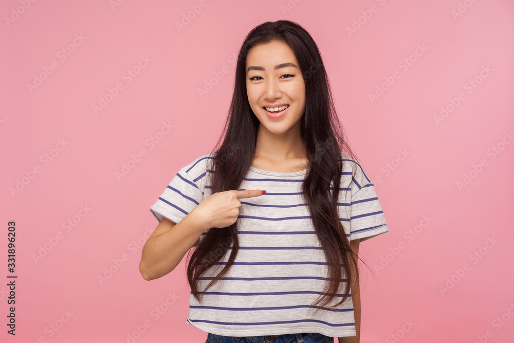 This is me! Petty girl with long hair pointing to herself and smiling joyfully, boasting achievements, proud of personal success, gesturing I'm the best. indoor studio shot isolated on pink background This is me! Petty girl with long hair pointing to herself and smiling joyfully, boasting achievements, proud of personal success, gesturing I'm the best. indoor studio shot isolated on pink background