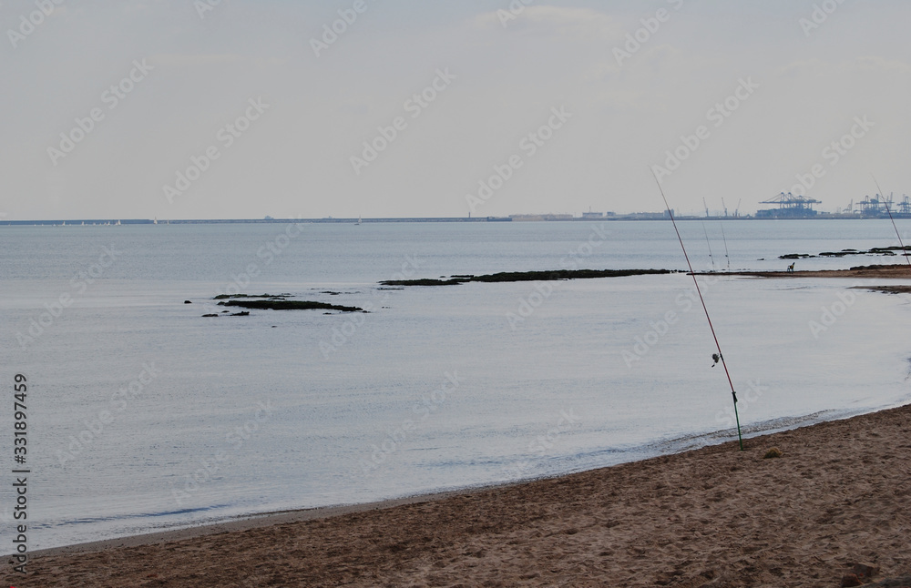 Fishing rods on the shore of the beach
