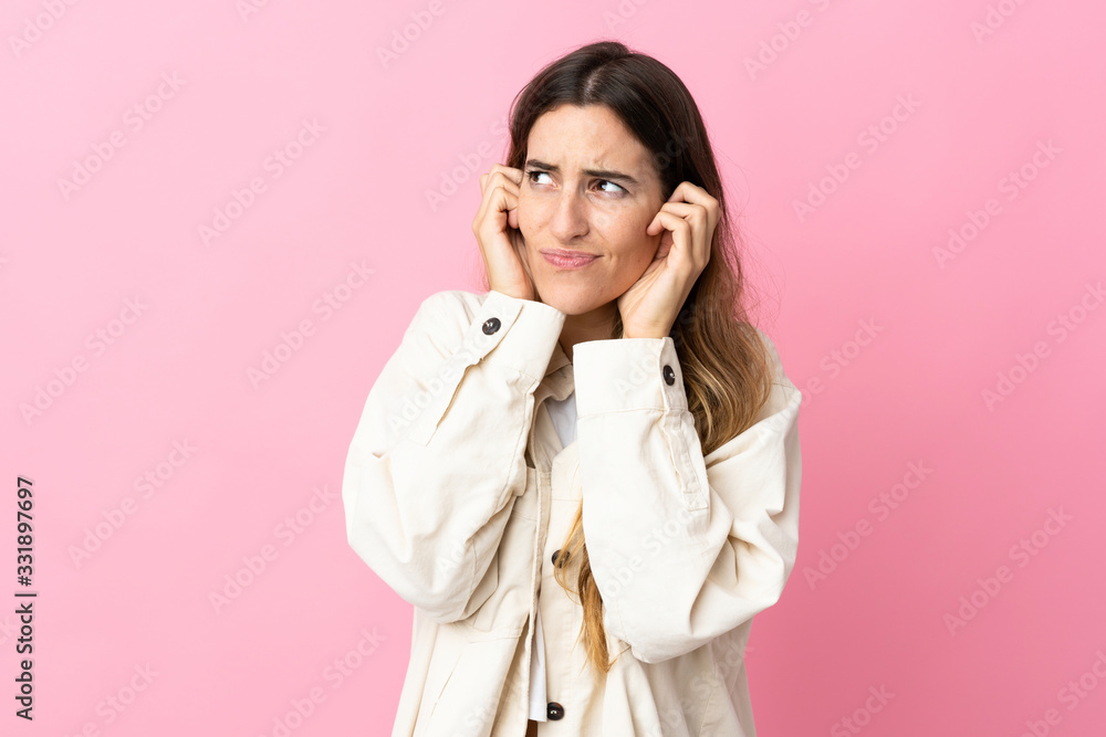 Young caucasian woman isolated on pink background frustrated and covering ears Young caucasian woman isolated on pink background frustrated and covering ears