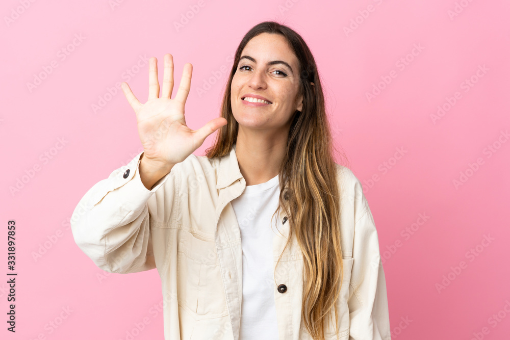 Young caucasian woman isolated on pink background counting five with fingers Young caucasian woman isolated on pink background counting five with fingers