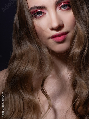 Fashion portrait of a young beautiful woman with long blonde hair.