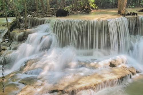 Beautiful soft silky white water flowing on arch rock with nature background  Huay Mae Khamin Waterfall floor 6th  Dong Pee Sua  Kanchanaburi  west of Thailand.