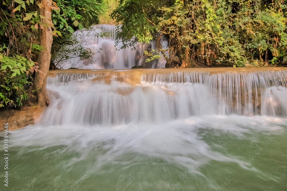 view of white silky water flowing around with green forest background, Huay Mae Khamin Waterfall floor 3th (Wang Nar Pha) Kanchanaburi, west of Thailand.