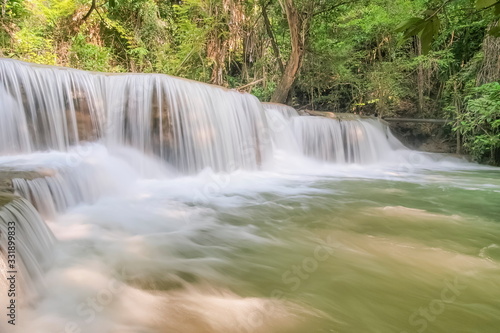 view of white silky water flowing around with green forest background, Huay Mae Khamin Waterfall floor 3th (Wang Nar Pha) Kanchanaburi, west of Thailand.