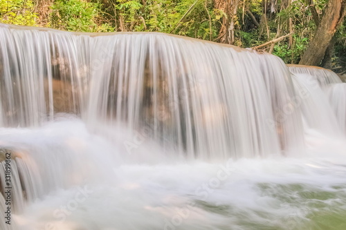 view of white silky water flowing around with green forest background, Huay Mae Khamin Waterfall floor 3th (Wang Nar Pha) Kanchanaburi, west of Thailand.