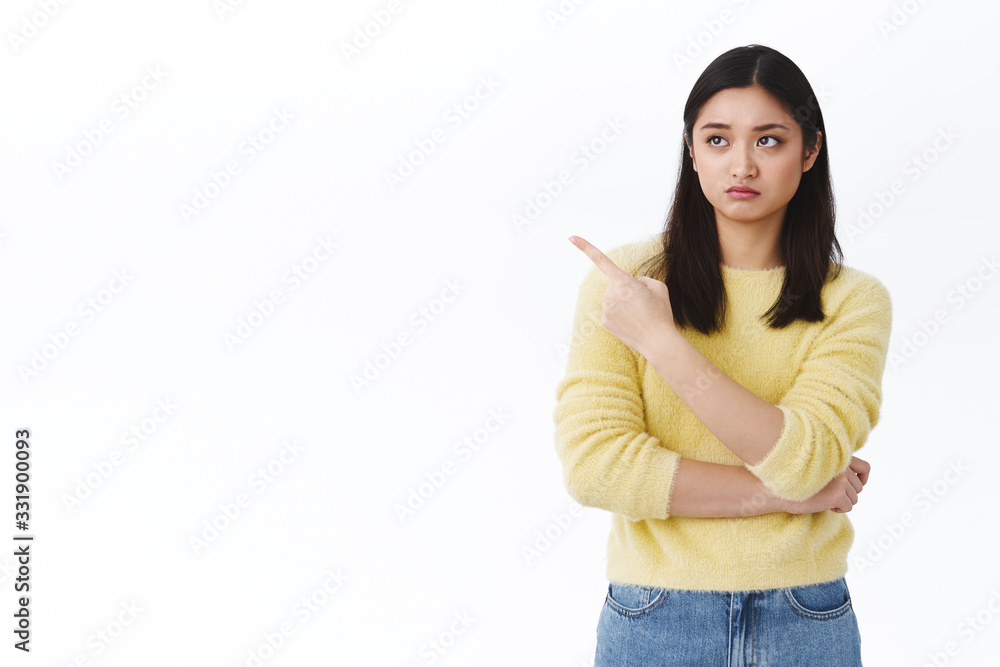 Skeptical and sulky cute asian picky girlfriend dont like it, pointing and looking disappointed left, seeing something unsatisfying grimacing like snob, being arrogant while talking to store clerk Skeptical and sulky cute asian picky girlfriend dont like it, pointing and looking disappointed left, seeing something unsatisfying grimacing like snob, being arrogant while talking to store clerk