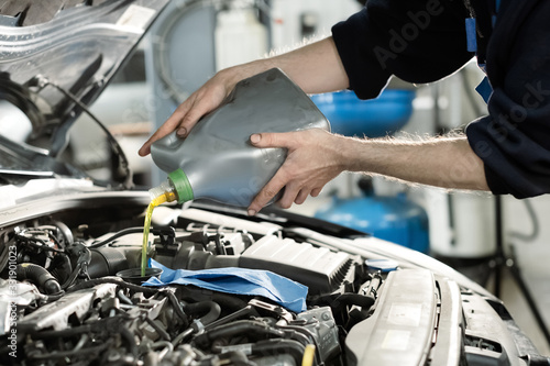 Hand mechanic in repairing car,Change the Oil.Car maintenance, concept. Middle shoot © smishura