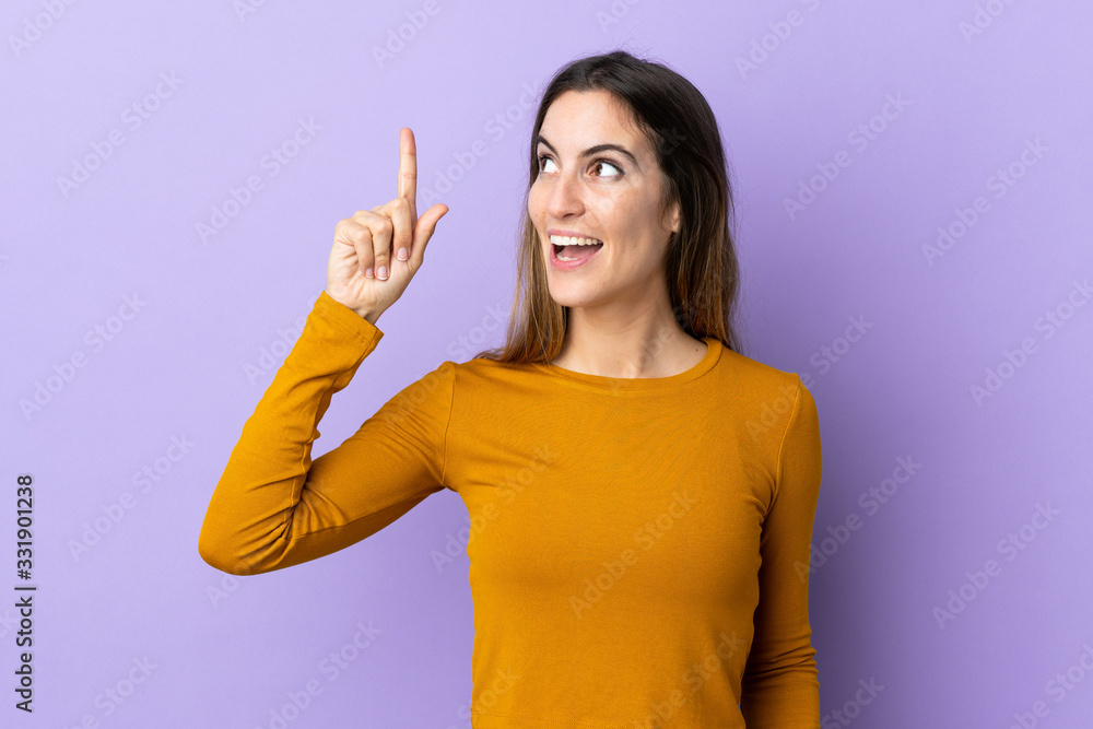 Young caucasian woman over isolated background intending to realizes the solution while lifting a finger up Young caucasian woman over isolated background intending to realizes the solution while lifting a finger up