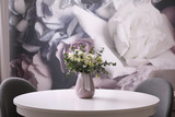 Vase with beautiful bouquet on white table indoors. Stylish interior element