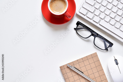 Top view office table, Creative design on table desk has book, pen, keyboard, mouse, eyeglasses and coffee cup with copy space.