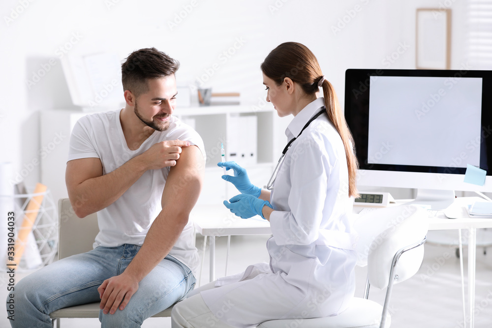 Doctor giving injection to patient in hospital. Vaccination concept Doctor giving injection to patient in hospital. Vaccination concept