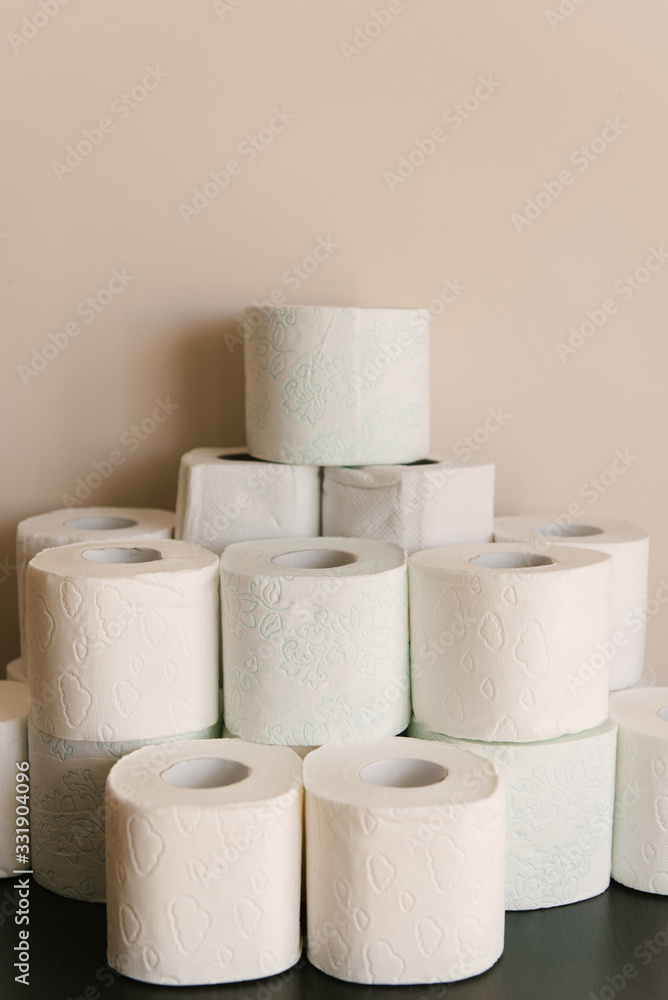 Toilet paper roll background with text toilet paper to 1 package per household. Concept of lack of toilet paper in stores due to coronavirus, Covid-19, hygiene, panic. Toilet paper roll background with text toilet paper to 1 package per household. Concept of lack of toilet paper in stores due to coronavirus, Covid-19, hygiene, panic.