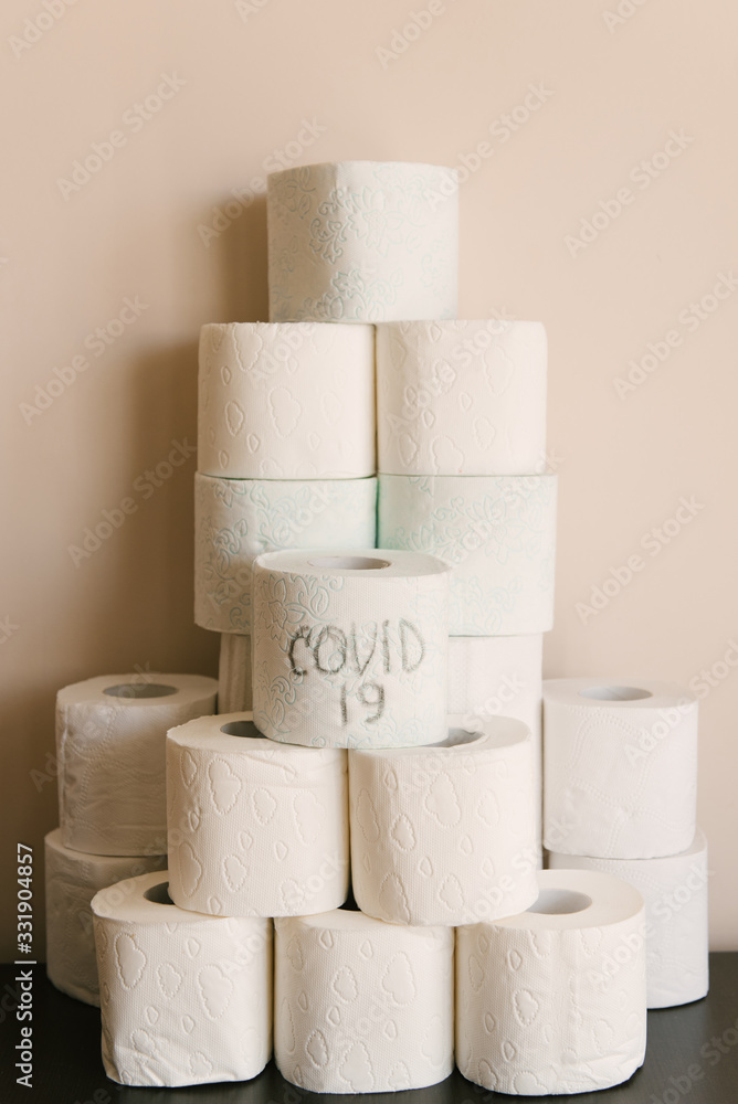 Toilet paper roll background with text toilet paper to 1 package per household. Concept of lack of toilet paper in stores due to coronavirus, Covid-19, hygiene, panic. Toilet paper roll background with text toilet paper to 1 package per household. Concept of lack of toilet paper in stores due to coronavirus, Covid-19, hygiene, panic.