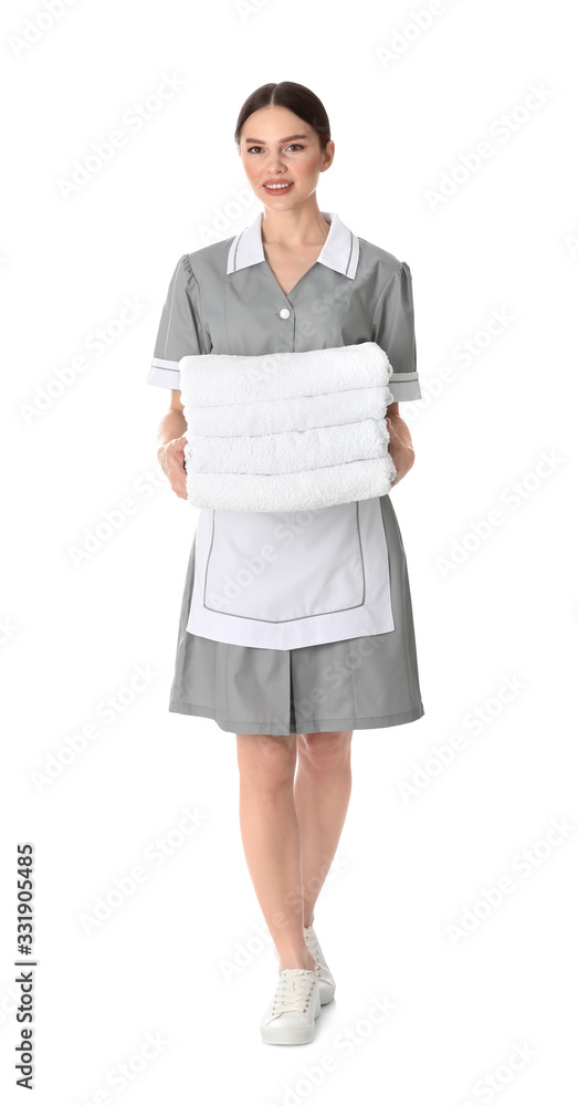 Young chambermaid holding stack of fresh towels on white background Young chambermaid holding stack of fresh towels on white background