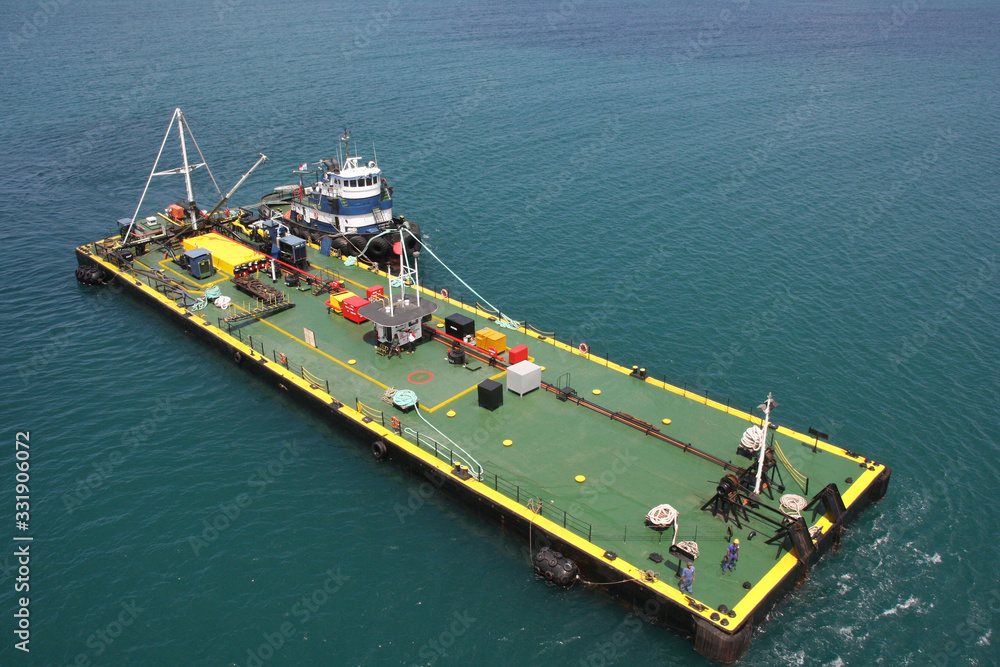 A tugboat pushing a barge