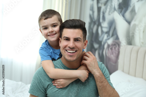 Dad and son spending time together at home. Happy Father's Day